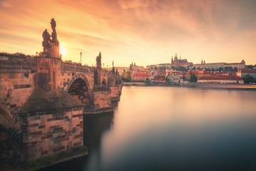 Fototapeta premium Sunset view over Charles Bridge (Karlov Most), Vltava river and Prague Castle in summer in Prague, capital of Czech Republic