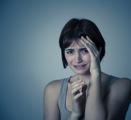 Portrait of a young attractive woman looking scared and shocked.Human expressions and emotions