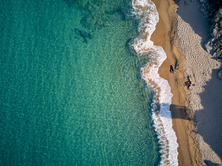 Beautiful beach with family top aerial view drone shot, Sithonia, Greece