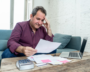 Upset middle aged man stressed about credit card debts and payments not happy accounting finances
