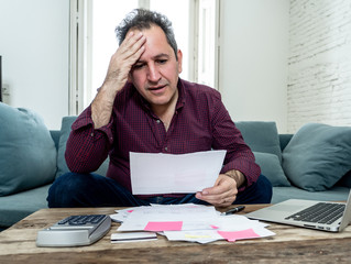 Upset middle aged man stressed about credit card debts and payments not happy accounting finances