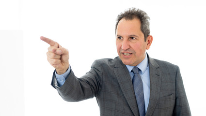 Portrait of a middle aged confident businessman pointing at copy space. Isolated on white.