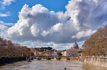 Obraz premium St. Peter's cathedral and Tiber river with high water in February. Saint Peter Basilica in Vatican city with Saint Angelo Bridge in Rome, Italy
