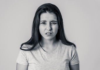 Portrait of a beautiful young woman with angry and serious face. Human expressions and emotions