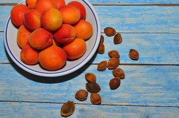 Ripe apricots in a bowl with stones.