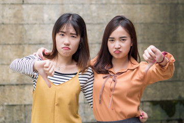 asian women showing rejecting thumb down gesture