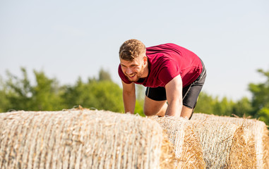Haystack obstacles at the extreme race overcome by runner