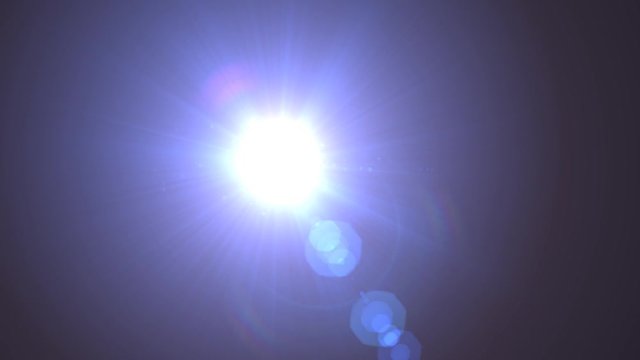 Diagonal Moving lens flare effect on black background. 4k animation.