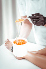 Skilled professional master in white uniform checking sugar paste