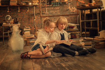 preschooler scientists studying chemistry in the class while sitting on the floor