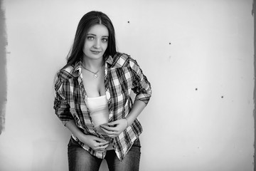 The builder makes repairs in the apartment. Finishing works on plastering and painting of walls. Masters work with paint drill and electricity.