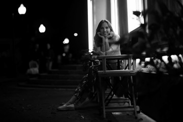 Girl sitting in a chair at night