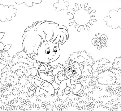 Smiling little boy playing with a small cheerful kitten among flowers on grass of a lawn on a sunny summer day, black and white vector illustration in a cartoon style for a coloring book