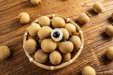 Fresh longan with fruits on wooden table