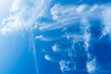 Blue sky background with white clouds.