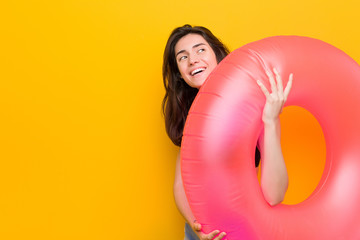 Young caucasian woman holding a float