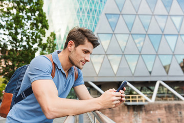 Handsome young man dressed casually spending time outdoors