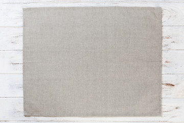 Fototapeta premium gray cloth napkin on white rustic wooden background top view with copy space