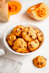 Pumpkin cookies with chocolate chips made from cake mix in a white ceramic bowl.