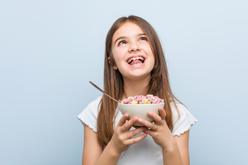 Little caucasian girl holding a cereal bowl