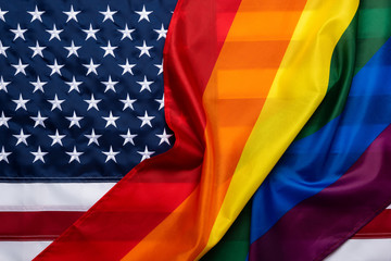 Pride rainbow lgbt gay flag over american flag . Equality diversity freedom in USA concept.