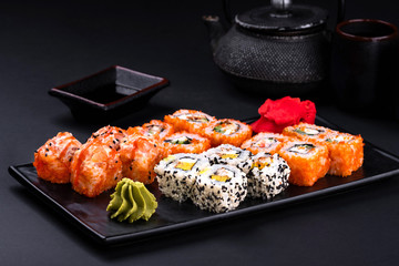 Close up rainbow Sushi Roll with salmon, eel, tuna, avocado, royal prawn, cream cheese...