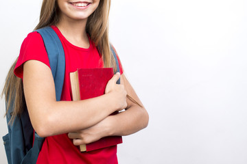 Smart schoolgirl carrying textbook