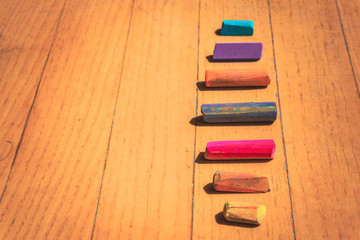 Pastel crayons on wooden background
