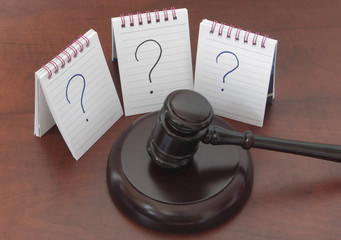 Legal questions and answers concept, question marks and judge gavel on wooden table