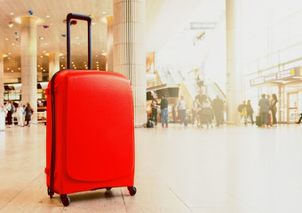 Suitcase in airport airport terminal waiting area with lounge zone as a background. Traveling...