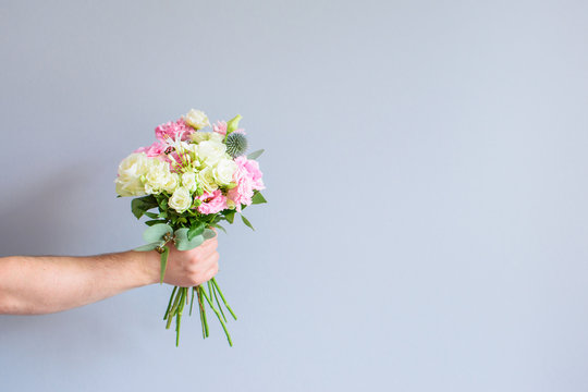 Hand With A Bouquet Of Flowers.