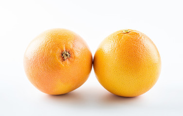 Two orange fresh grapefruits on white background