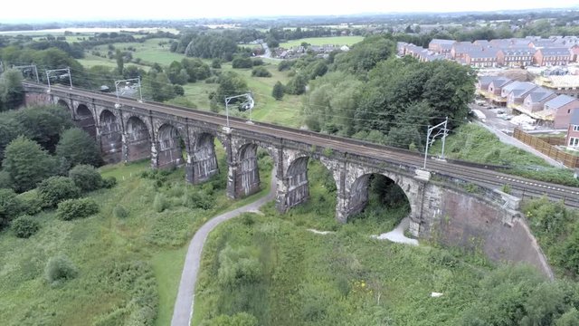 Sankey viaduct aerial above historical British railway arched bridge crossing. Aerial orbit right.