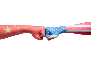 Hands of two men with Chinese skin and American skin bumping their fists