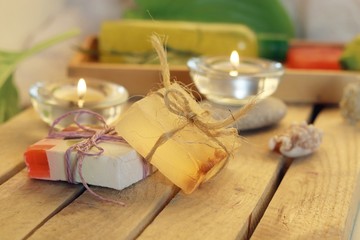 Fototapeta na wymiar Natural soap, candles, sea salt, plants, stones, shells on the table, spa procedures, relaxation, healthy lifestyle 