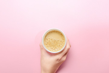 Hand holding a styrofoam cup of hot coffee