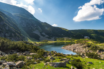 Naklejka na ściany i meble Panoramic photo of summer mountain valley. Fabulous warm day in the mountains, amazing nature. Travel and hike