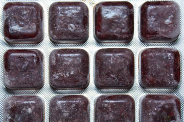 Frozen bloodworm close up. Food for aquarium fish. Freeze bloodworms fish food for aquarium.