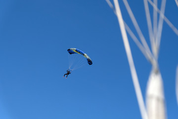 Skydiving. A parachute is in the sky.