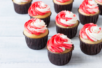 Delicious birthday cupcakes with red-white cream.