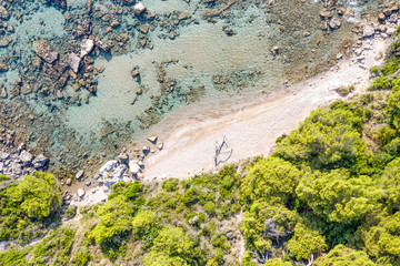 Aerial view of beautiful seashore in summer. Rocky beach and green islands seen from above.