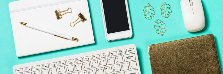 Office workplace with keyboard, notepad, glasses and pen