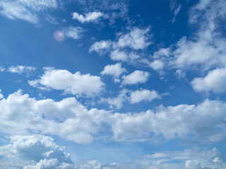 Naklejka na ściany i meble Sunny background, blue sky with white clouds and sun, Natural landscape