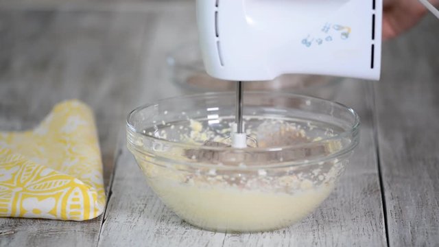 Mixing Cocoa Powder, Flour and Beaten Eggs. Making Chocolate Layer Cake.