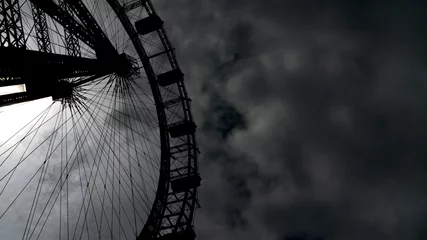 Photo sur Plexiglas Vienne The classic Ferris Wheel of Prater Amusement Park in Vienna, Austria, dark clouds enveloping. Graham Greene and The Third Man Orson Welles rode it in the book and the Film Noir.