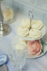 Home-made vanilla muffins with fresh berries on a stand. Zefir. A festive table. A sweet table.