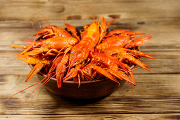 Boiled crayfish in plate on wooden table