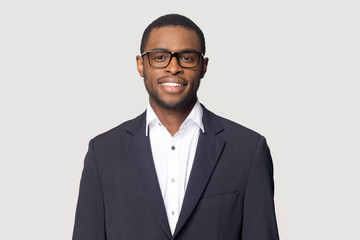 Fototapeta Smiling black man in suit posing on studio background obraz