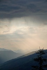 Fototapeta na wymiar beautiful sunset and view in the mountains with rain, fog and sunbeams