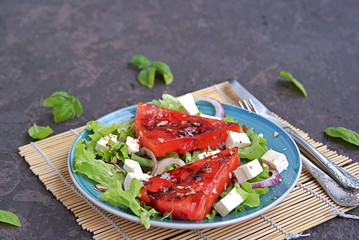 Summer salad of watermelon grilled, feta cheese and onions. Dressed with balsamic vinegar and olive oil. Selective focus. Healthy food.